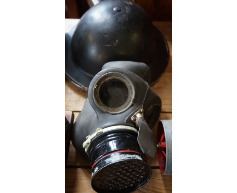 A vintage World War II helmet and gas mask.