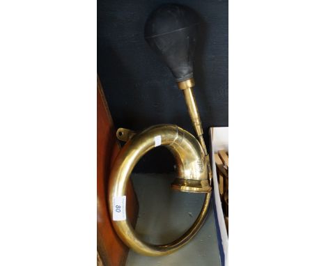 A vintage deluxe brass car horn.