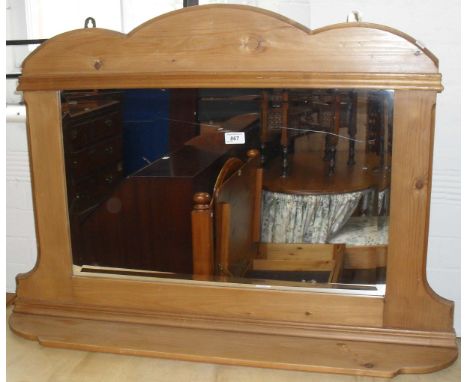 A pine overmantle mirror, with bevelled edge plate.
