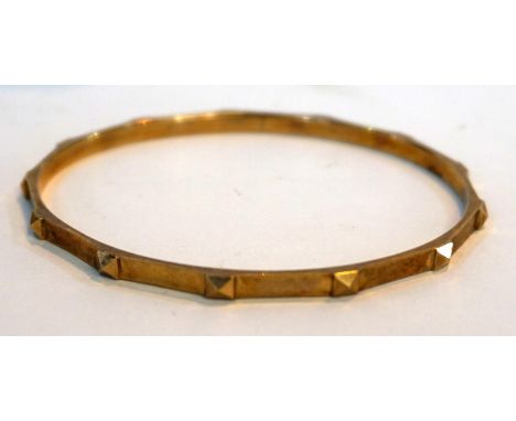 A stylish 9ct gold bangle with cast studs, approx 22gms.