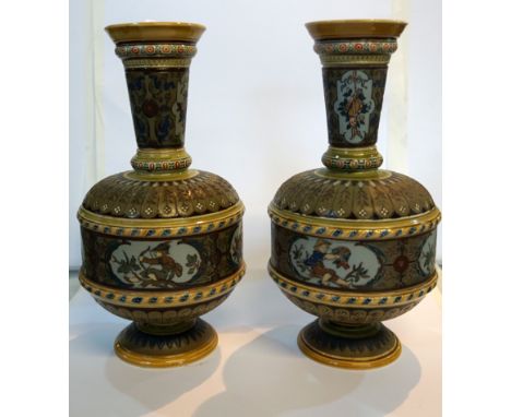 A pair of Mettlach German stoneware vases, of baluster form with cylindrical flared necks, having incised decoration depictin