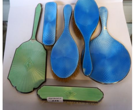 A mixed collection of enamelled backed and hallmarked silver dressing table items to include a green enamel clothes brush and
