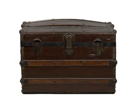 Domed top trunk of lath and canvas construction, with medal bonding and leather carry straps, the latched lid opening to reve