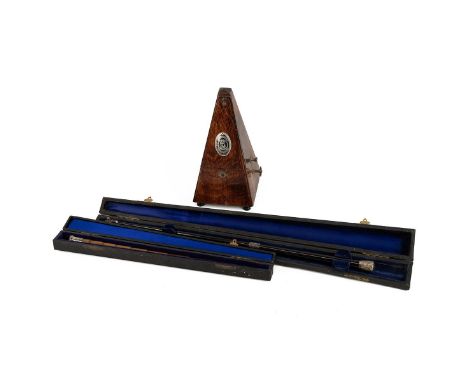 Two conductor's batons and a metronome. The first by Callow and Sons, carved to appear as bamboo, with a silver handle hallma