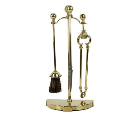 Early 20th century brass fireside companion set comprising poker, tongs, brush and stand. Height 45cm.