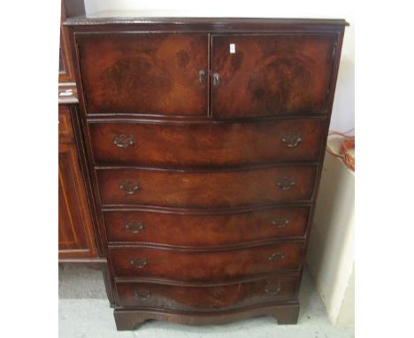 Reproduction walnut serpentine bedroom chest of five long drawers on bracket feet.(B.P. 24% incl. VAT)