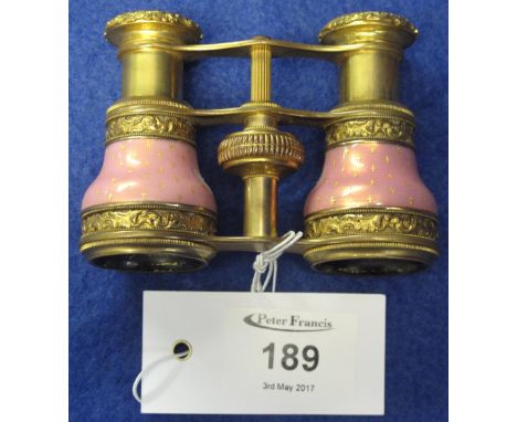 Pair of gilt metal, pink enamel, French opera glasses, stamped: France, with retailers mark around eye piece: S. Beck, Dallas