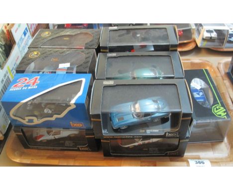 Thirteen 1:43 scale diecast model cars in original packaging and perspex cases to include: Ixo and MG Sport and Racing. (13)(