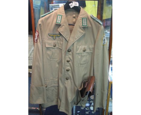 German army officer's grey tunic and a desert theatre shirt, together with a leather pistol holster.(B.P. 24% incl. VAT)