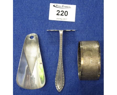 Small silver shoe horn, silver baby's pusher and silver napkin ring. (3)(B.P. 24% incl. VAT)