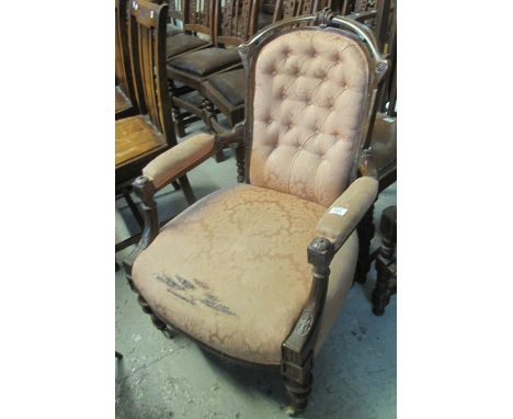 Victorian button back upholstered fireside open armchair on ring turned legs and casters.(B.P. 24% incl. VAT)