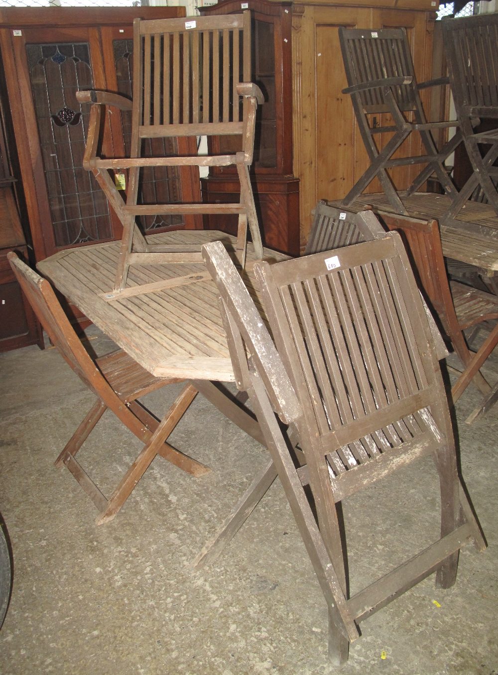 Modern teak garden table together with a set of four chairs. (5)(B.P
