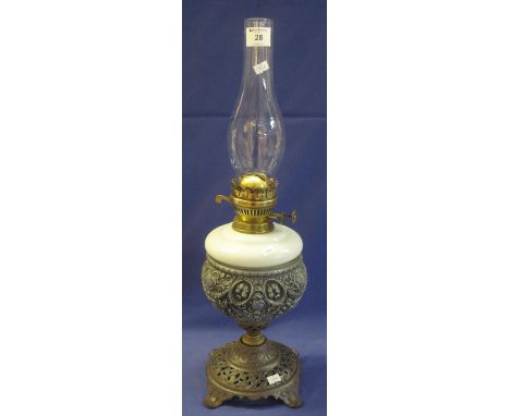 Brass double burner oil lamp with ceramic reservoir set on a cast metal base with clear chimney.(B.P. 24% incl. VAT)
