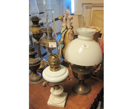 Brass oil lamp with opaque glass shade and clear chimney, together with another brass double burner oil lamp with ceramic res
