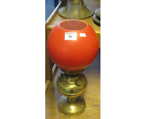 Single brass double burner oil lamp on pedestal base with coloured shade and clear chimney.(B.P. 24% incl. VAT)