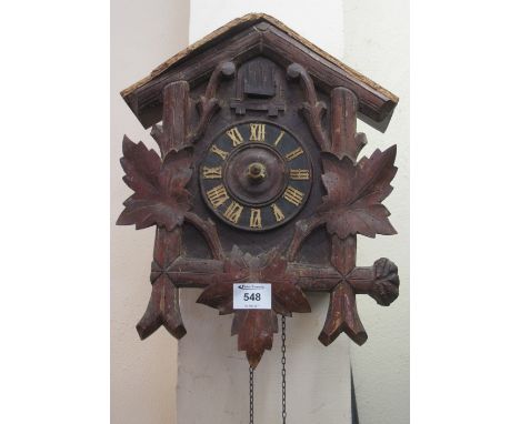 Stained and carved cuckoo clock with weights and pendulum.(B.P. 24% incl. VAT)