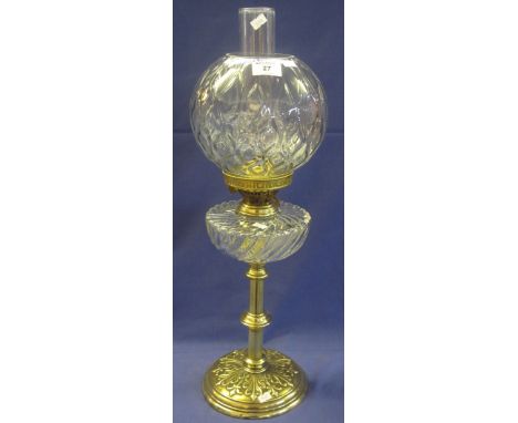 Early 20th Century brass double burner oil lamp, having wrythen glass reservoir on brass pedestal with repousse circular base