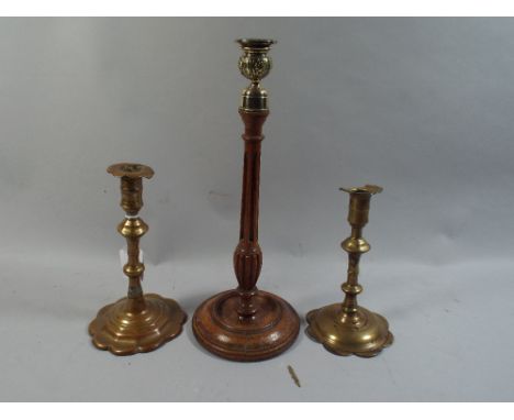 A Turned Wooden Candle Stick with Brass Top and Pair of Brass Candle Sticks.