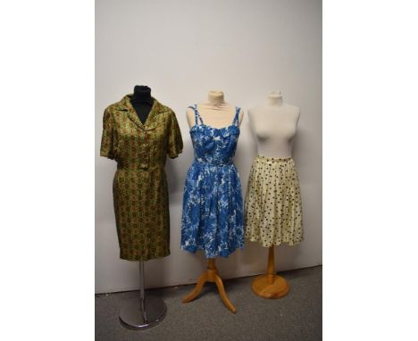A 1950s day dress having buttons to front and side metal zip, motif pattern in brown, mustard and green, AF, underarm damage,