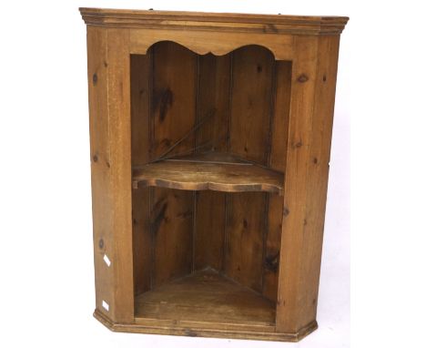 A 20th century pine corner cabinet, with single fixed shelf, within moulded rims, 78 cm high