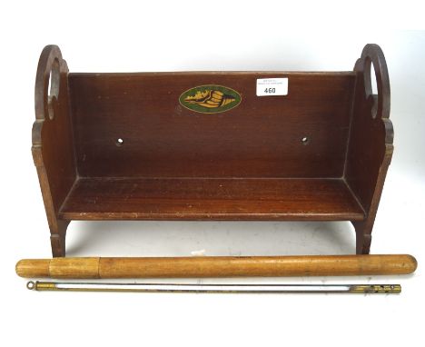 A early 20th century mahogany book trough, decorated with an inlaid image of a shell L45cm