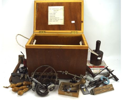 A collection of vintage tools, including weights, a roller etc, within a hinged wooden box