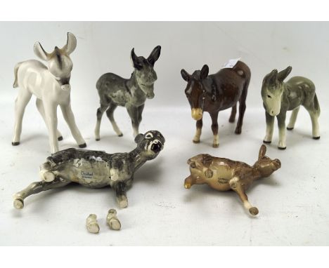 A collection of Beswick donkeys, together with one Goebel example, maximim height 14.5cm, some AF