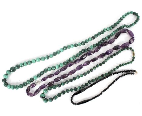 A group of four ladies necklaces, including jet, amethyst and malachite beads with sterling silver and a 9ct gold catch