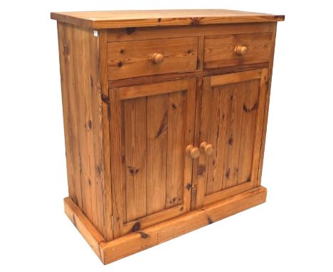 A pine kitchern cupboard, with two short drawers above two panelled doors, enclosing a shelf, L86.5 x D40.5 cm x H89