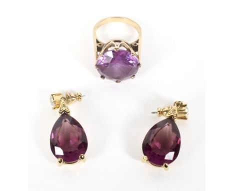 A yellow mental amethyst dress ring of large proportion, indistinct hallmark together with a pair of amethyst drop earings