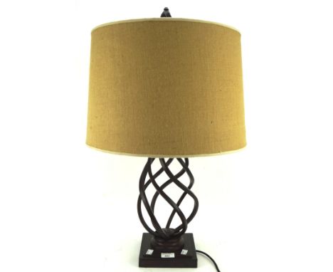 A contemporary table lamp, the metal frame modelled with a spiral effect on a square base, with a brown shade, height (includ