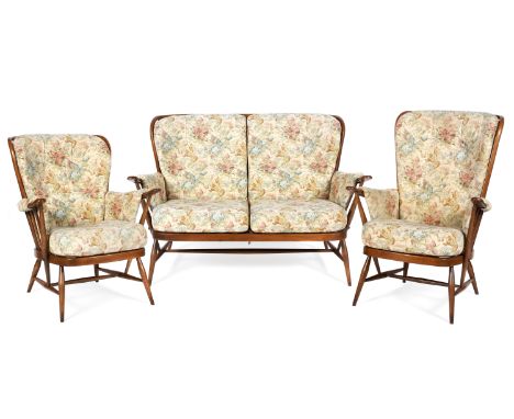 An Ercol spindle back upholstered three piece suite design 9142, 18/12/89, sofa L140cm x H91cm