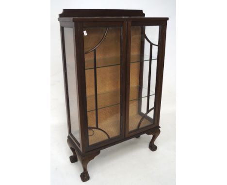 An early 20th century glazed mahogany display cabinet, the glazed astragal fronted double doors, enclosing one glass shelf, o