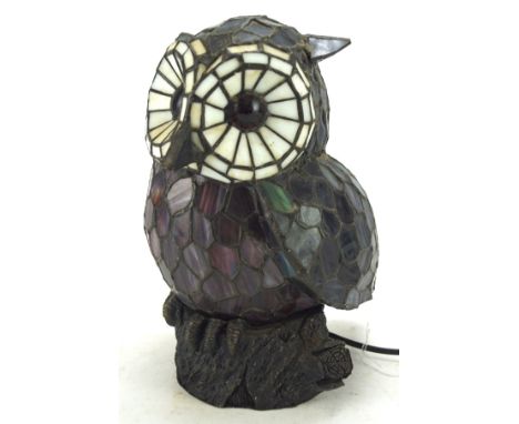 A Tiffany style owl shaped table lamp, perched on rocky metal base, electrified, H27cm