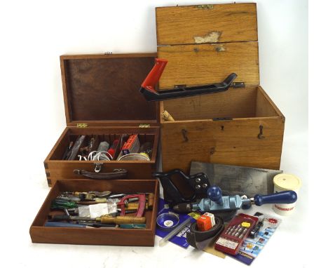 A group of tools in hinged wooden cases, including: saws, a Footprint drill, files, smal hand tools and other items 