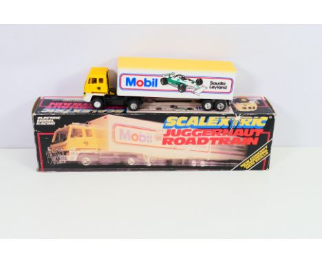 Scalextric - A boxed Scalextric C301 Juggernaut Roadtrain. The model has some fading / staining to one side and appears to be