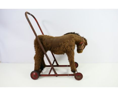 An early 20th century push along mohair Donkey of high quality, our vendor informs us that he received this as a gift for his