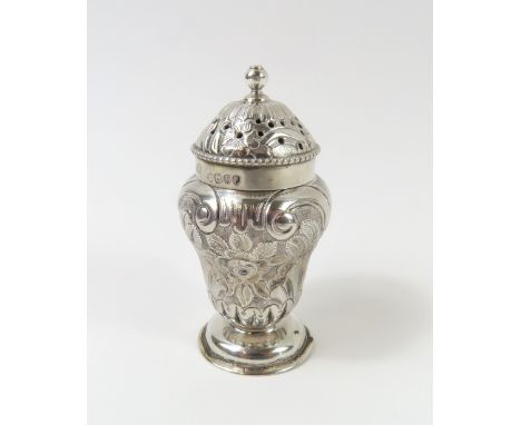 A Victorian silver pepper pot with gilt interior, and embossed roses and other floral designs on exterior. Made by JB, possib