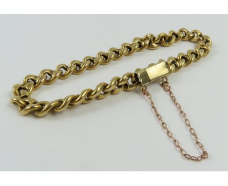 A thick figure of eight type link bracelet, each link marked '18' with a crown, possibly originally part of a longer chain, w
