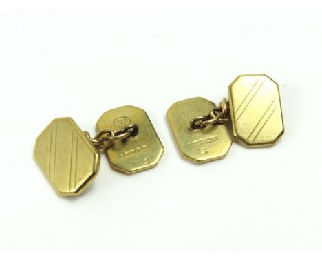 A pair of early to mid-20th century 9ct gold cufflinks, the rectangular panels with cantered corners and line pattern decorat