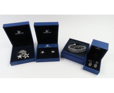 Swarovski - a necklace set with two starfish pendants, both set with clear crystals, a pair of stud earrings set with clear c