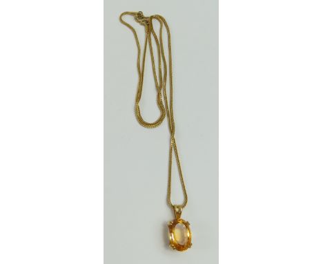 An oval facetted citrine in a double four claw cup type setting, on a long fish tail link chain, the chain and mount acid tes