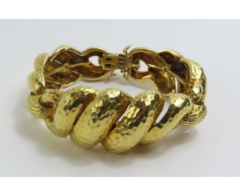 David Webb - a vintage gold articulated link bracelet, composed of three planished twisted sections joined by oval links with