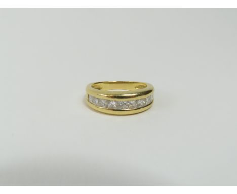 A princess cut diamond half eternity ring, the nine stones channel set, diamond total weight approximately 0.79ct, marked '75