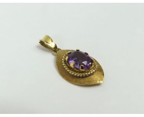 An amethyst pendant, the oval facetted stone with a rope twist surround on a stylised textured leaf shape, acid tests as appr