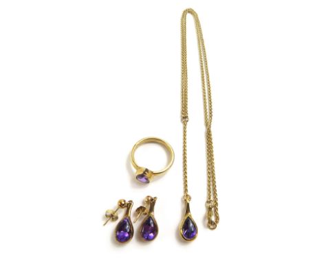 A 9ct gold amethyst ring, the pear shaped cabochon cut amethyst in a rub-over mount; a pair of matching 9ct gold drop earring