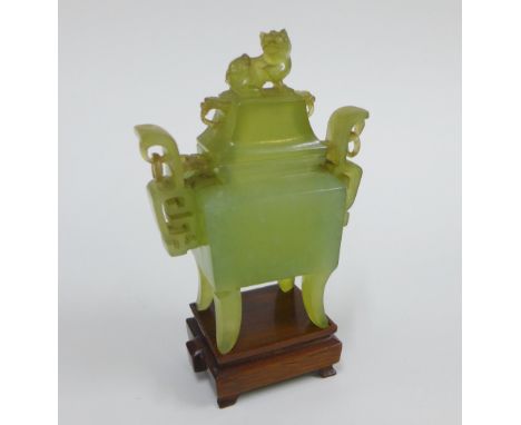 Chinese jade Koro and cover with Kylin finial and stylised pierced handles, on a wooden stand, height overall 15cm  