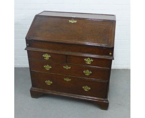 Georgian oak secretaire chest, with a fall front and fitted interior above pull out slide, two short and two graduating long 