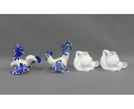 Pair of Crown Staffordshire white glazed china birds and two blue and white art pottery cockerels, (4)