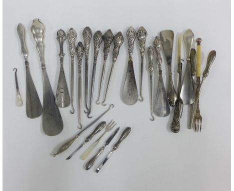 A collection of silver and white metal handled button hooks, shoe horns and pickle forks, etc (a lot) 